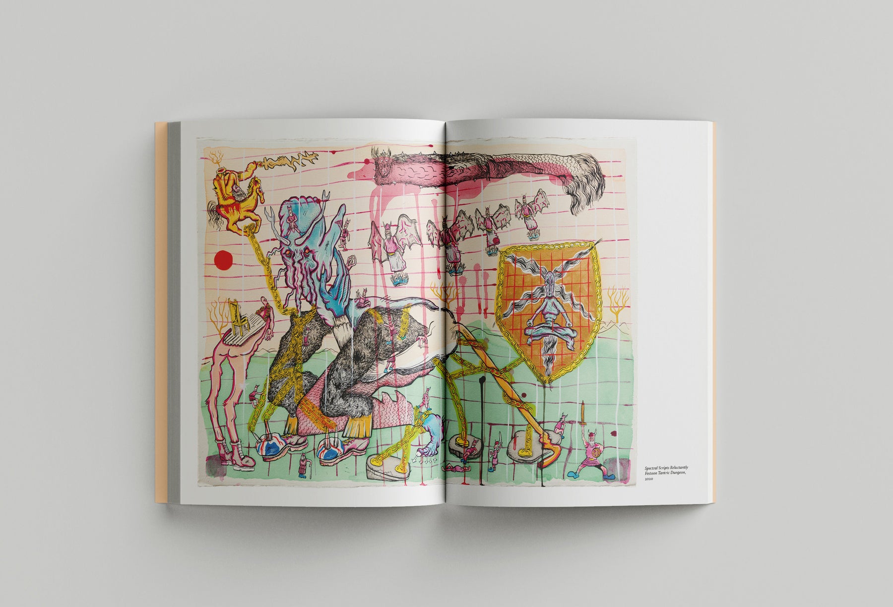 An open book, "Hardeep Pandhal: Inheritance Quest," published by Black Dog Press, displaying a colorful abstract artwork with various figures and shapes is laid flat on a gray surface, reflecting themes of migration and Sikh heritage as envisioned by Hardeep Pandhal.