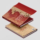 Two hardcover books, "Ambreen Butt: What Comes to My Lips" by Black Dog Online, with red and beige covers adorned with a map design, mirror the intricate style of an Indo-Persian miniature painting. The top book is open, showcasing its luxurious red interior.