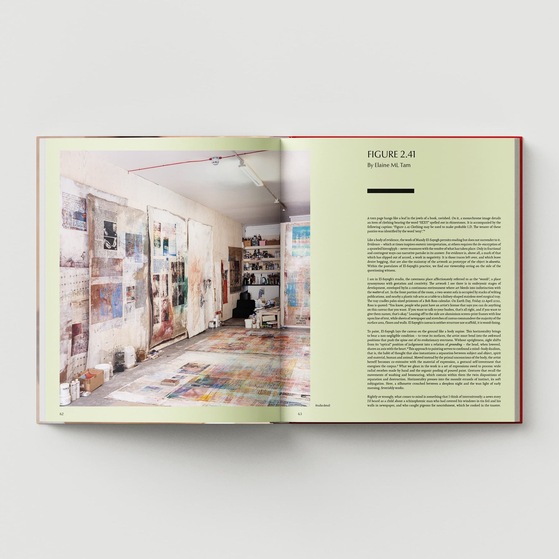 In "The Makeshift Body: Mandy El-Sayegh" by Black Dog Online, an open book displays a photograph of an art studio filled with canvases and paint supplies on the left page, while the right page features text. This monograph celebrates Mandy El-Sayegh, a contemporary artist renowned for her dynamic artworks that dissolve the boundaries between canvas and concept.