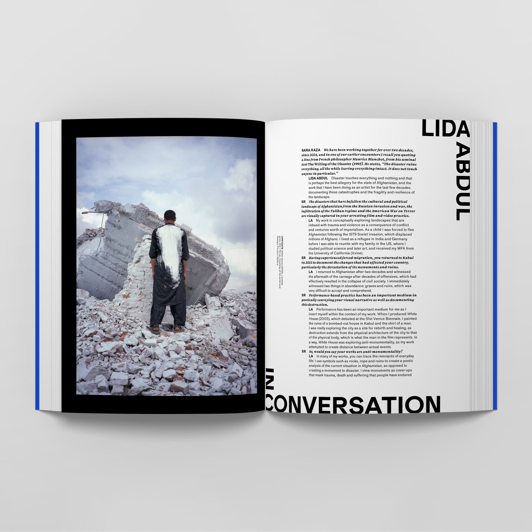 Open magazine showing an image of a person standing amidst rubble on the left page, and text on the right page titled "Punk Orientalism: The Art of Rebellion by Black Dog Online" with black text on a white background. The article delves into Punk Orientalism as it explores themes surrounding contemporary art in Central Asia.