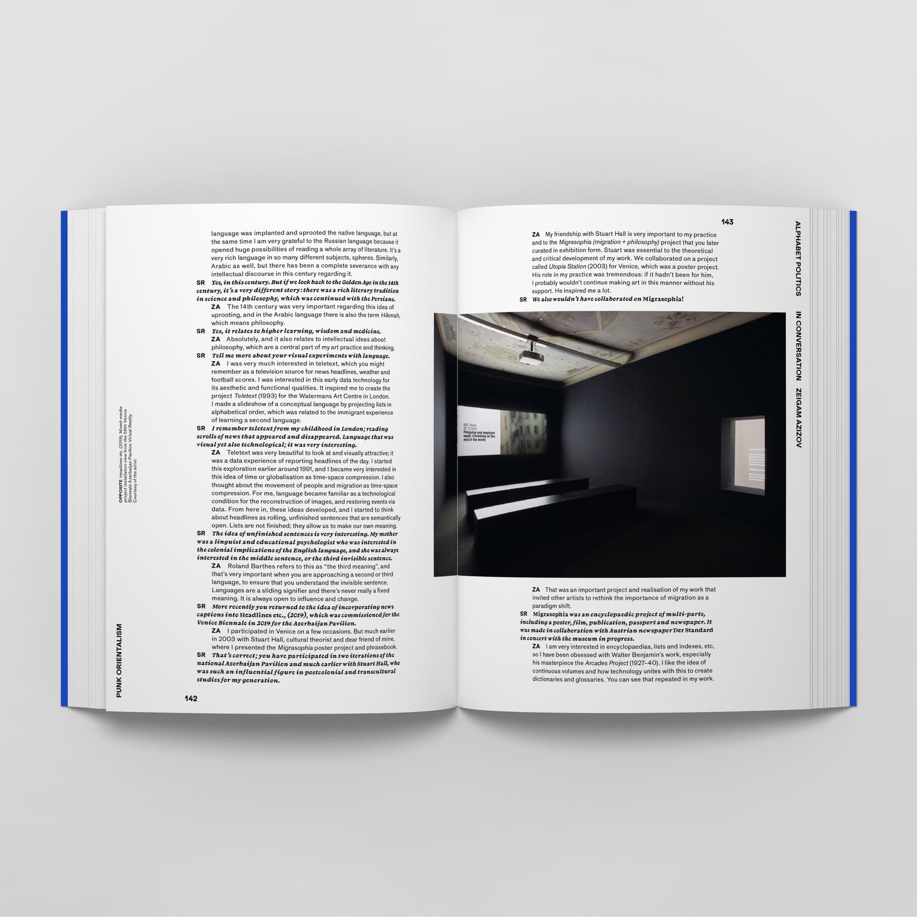 Open book displaying text on both pages and a photograph of a dark room with benches and a screen projection on the right page. The book, Punk Orientalism: The Art of Rebellion by Black Dog Online, is laid flat on a light gray surface.