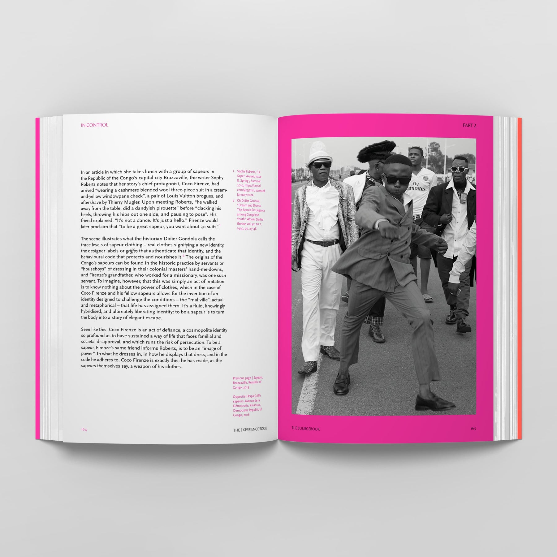 Open book showing a photograph of five people in stylish clothing on the right page and a block of text on the left page with pink borders, as if taken straight from "The Experience Book: For Designers, Thinkers & Makers" by Black Dog Online.
