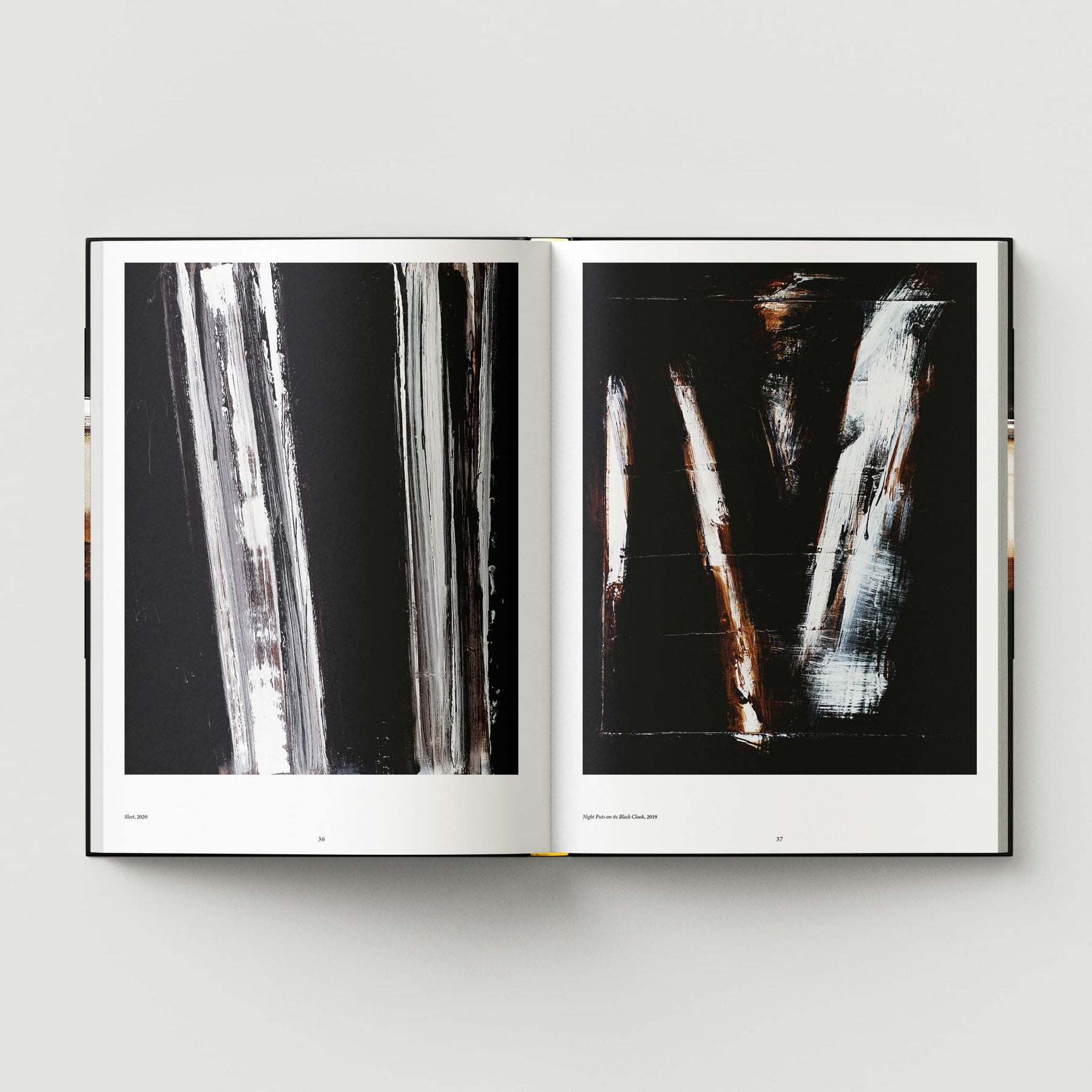 The book titled "Johnnie Cooper: The Listener" from Black Dog Online features an open spread showcasing abstract black and white artwork with vertical brushstrokes across both pages, evoking the mysterious shadows of a forest at night.