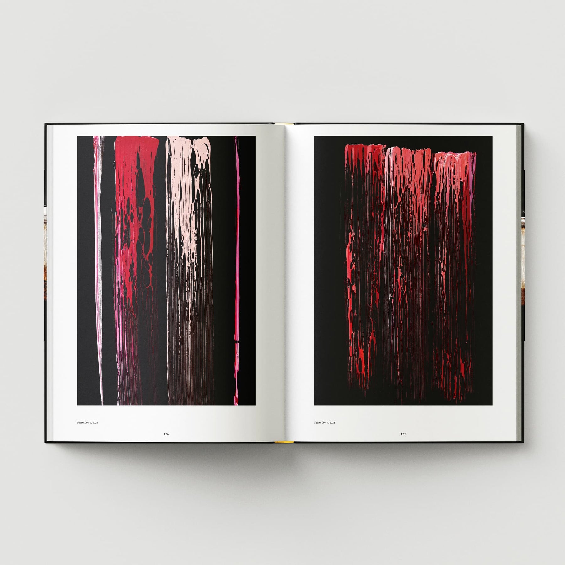 An open book featuring "Johnnie Cooper: The Listener" from Black Dog Online, showcasing two abstract paintings with vertical streaks in shades of red, pink, and black against dark backgrounds. This captivating work by the renowned British abstract artist evokes a polychromatic collection reminiscent of forest nighttime shadows.