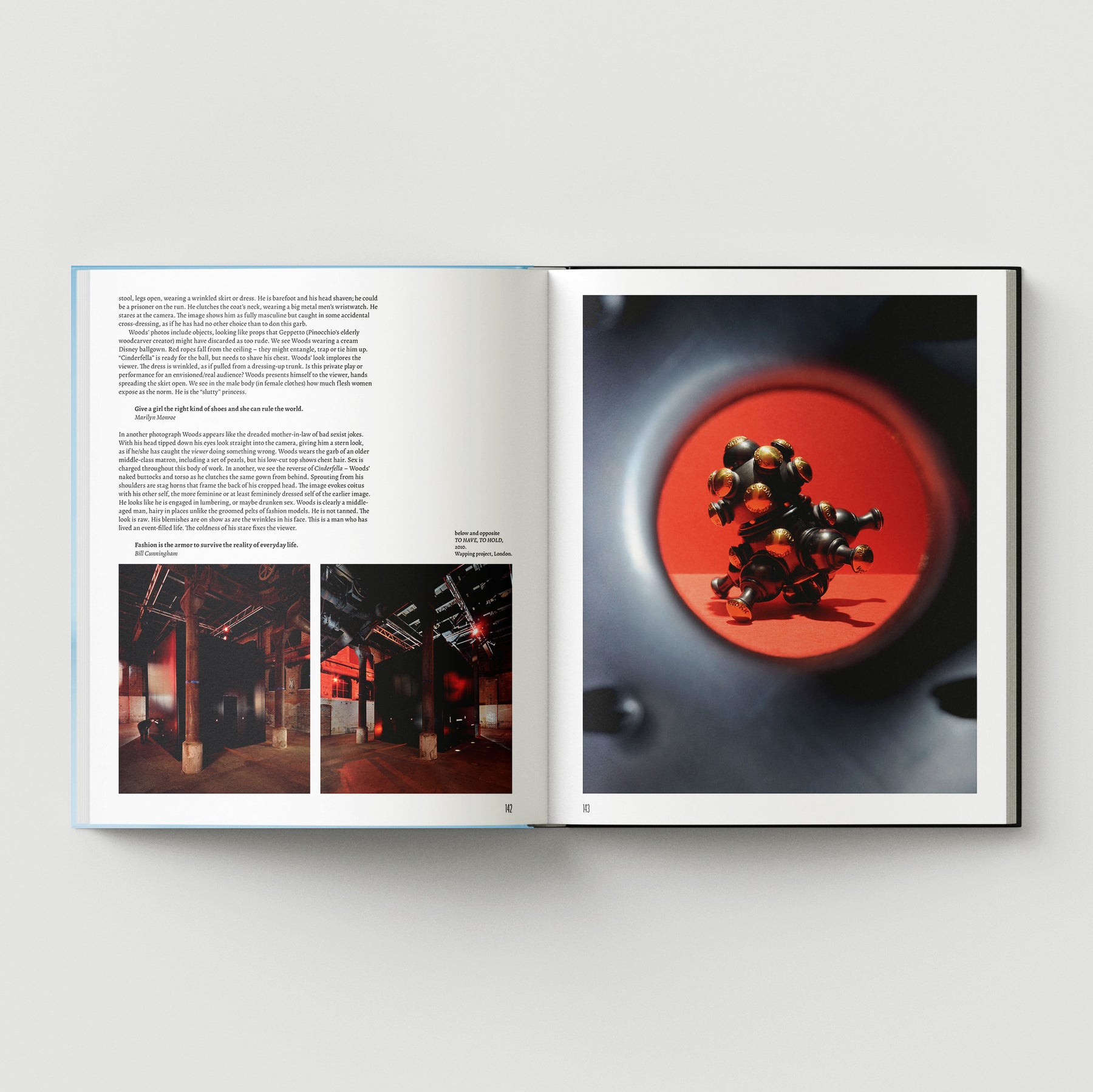 An open book, "Formula + Fetish" by Black Dog Press, displays text with two small photos on the left page and a close-up image of jewellery and fine art by British artist Mark Woods on a red background on the right page.
