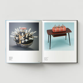 An open book titled "Formula + Fetish" by Black Dog Press shows a ceramic sculpture with protrusions by British artist Mark Woods on the left and a small table with four patterned objects on the right, illustrating his fusion of jewellery and fine art.